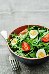 salad with arugula, spinach, tomatoes and eggs