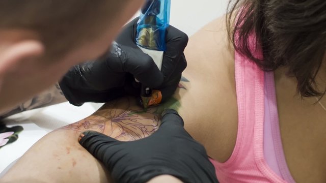 Woman being tattoed