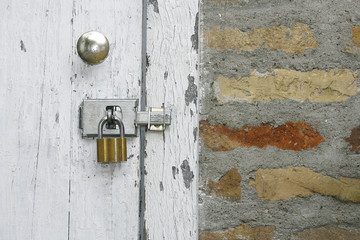 Old wooden rustic door with metal padlock