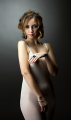 Flirtatious girl posing in negligee and jewels