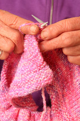 Close up of senior lady hands knitting.