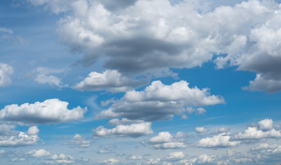 Cloudscape. The blue sky with white-grey clouds