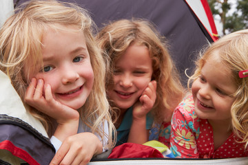 Three Girls Enjoying Camping Holiday On Campsite
