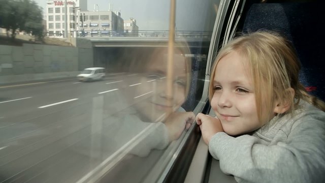 girl looking out the window on the train