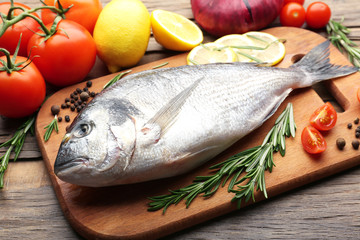 Fresh raw fish and food ingredients on table
