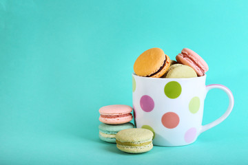 Assortment of gentle colorful macaroons in colorful mug