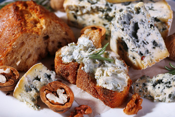 Blue cheese with sprigs of rosemary, bread and nuts