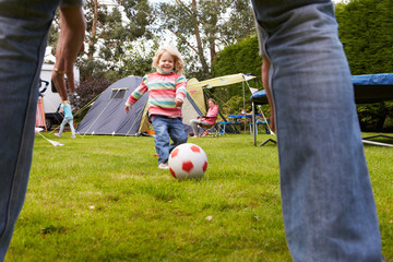Obraz premium Family Having Football Match On Camping Holiday
