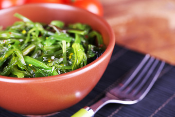 Seaweed salad in bowl with cherry tomatoes