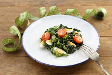 Salad with quail egg and basil in plate