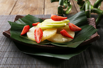 Fruit dessert on green leaf on table