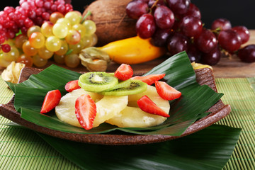 Fruit dessert on green leaf on table