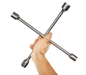 Cross wrench in male hand isolated on white