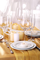 Beautiful holiday table setting in white and gold color