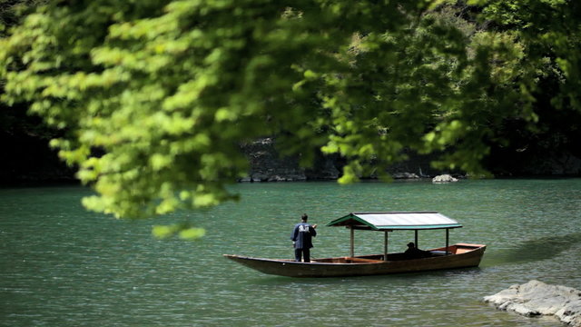 Boatman Katsura River tourists travel nature Arashiyama Kyoto Japan