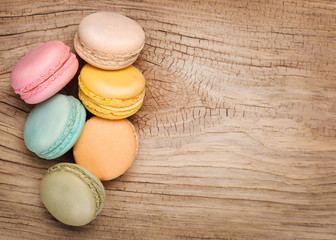Colorful French Macarons on wooden background