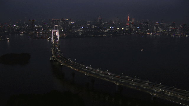 Aerial illuminated Metropolis city night Tokyo Bay Rainbow Bridge Odaiba Japan