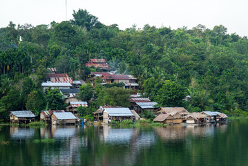 Obraz premium Village on mountain and riverside