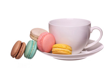 Colorful French Macarons with Cup of Tea isolated on white