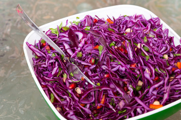 purple cabbage salad with pomegranate seeds and pepper