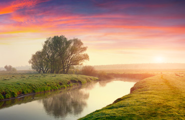 Fototapeta na wymiar Colorful summer sunrise on the river