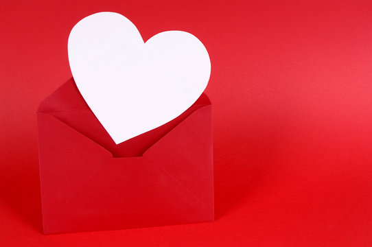 Heart shape red valentine card or gift tag in envelope isolated plain background photo