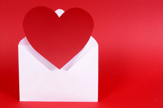 Heart shape red valentine card or gift tag in envelope isolated plain background photo