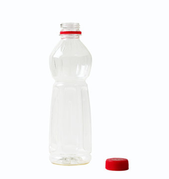 Empty plastic bottle opened with red cap.