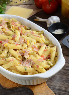 Penne pasta casserole with cheese, ham and corn