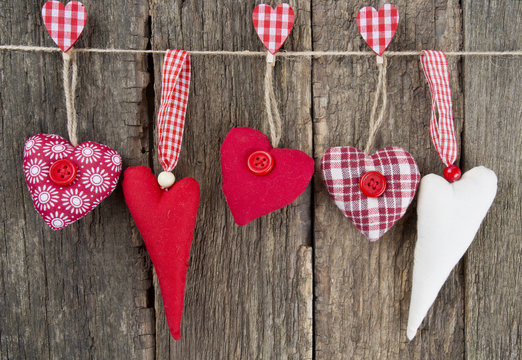 textile hearts on rustic wooden surface