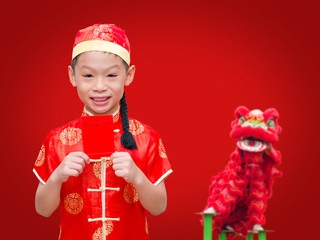 Asian boy with Chinese traditional dress holding ang pow or red