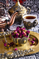 Dried rose buds in a metal Cup