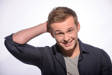 Cheerful young man posing in stylish look