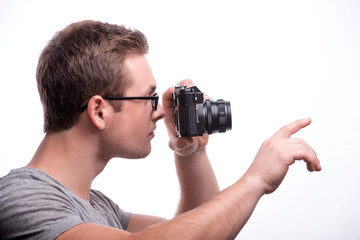 Young handsome man with photo camera