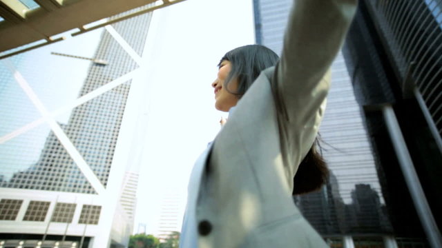 Young Ethnic Asian Chinese Businesswoman City Downtown Celebrating Achievements