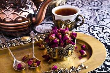 Dried rose buds in a metal Cup
