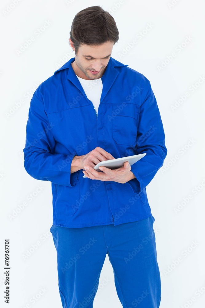 Poster mechanic using digital tablet over white background