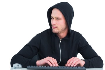 Stern hacker typing on keyboard