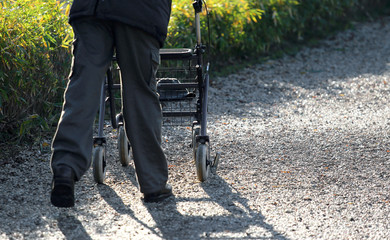 elderly with a Walker during the walk in the Park