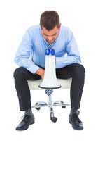 Businessman shouting through megaphone