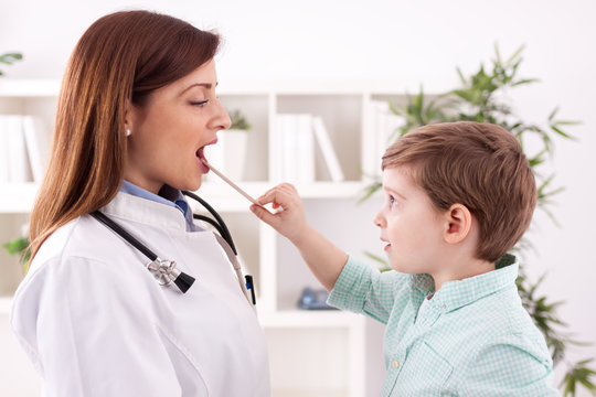 Little child playing with doctor examining
