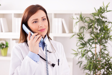 Smiling attractive female doctor talking with patient and schedu