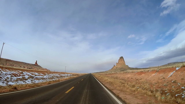 POV road vehicle driving sandstone Buttes snow Monument Plateau Valley  USA