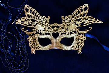 golden carnival mask on dark background