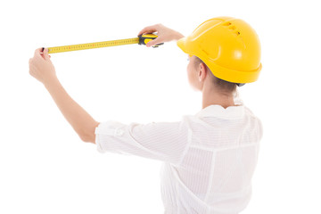 back view of business woman architect in yellow builder helmet w