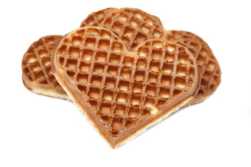 Waffle cookies in the form of hearts on a white background.