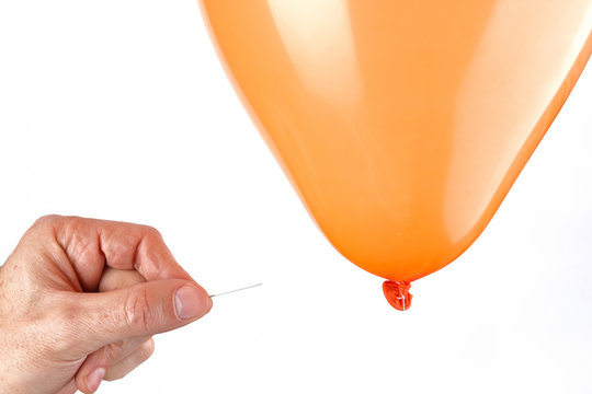 Man Pricking A Balloon With A Pin