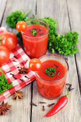 Tomato juice in glasses and fresh vegetables