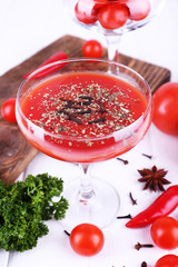 Tomato juice in goblet and fresh vegetables