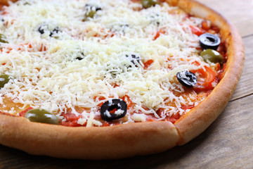 Pizza with cheese on wooden table background